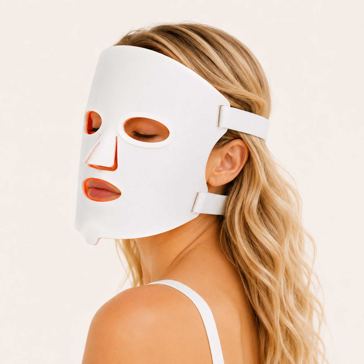 Woman wearing the AuraFace LED red light therapy face mask